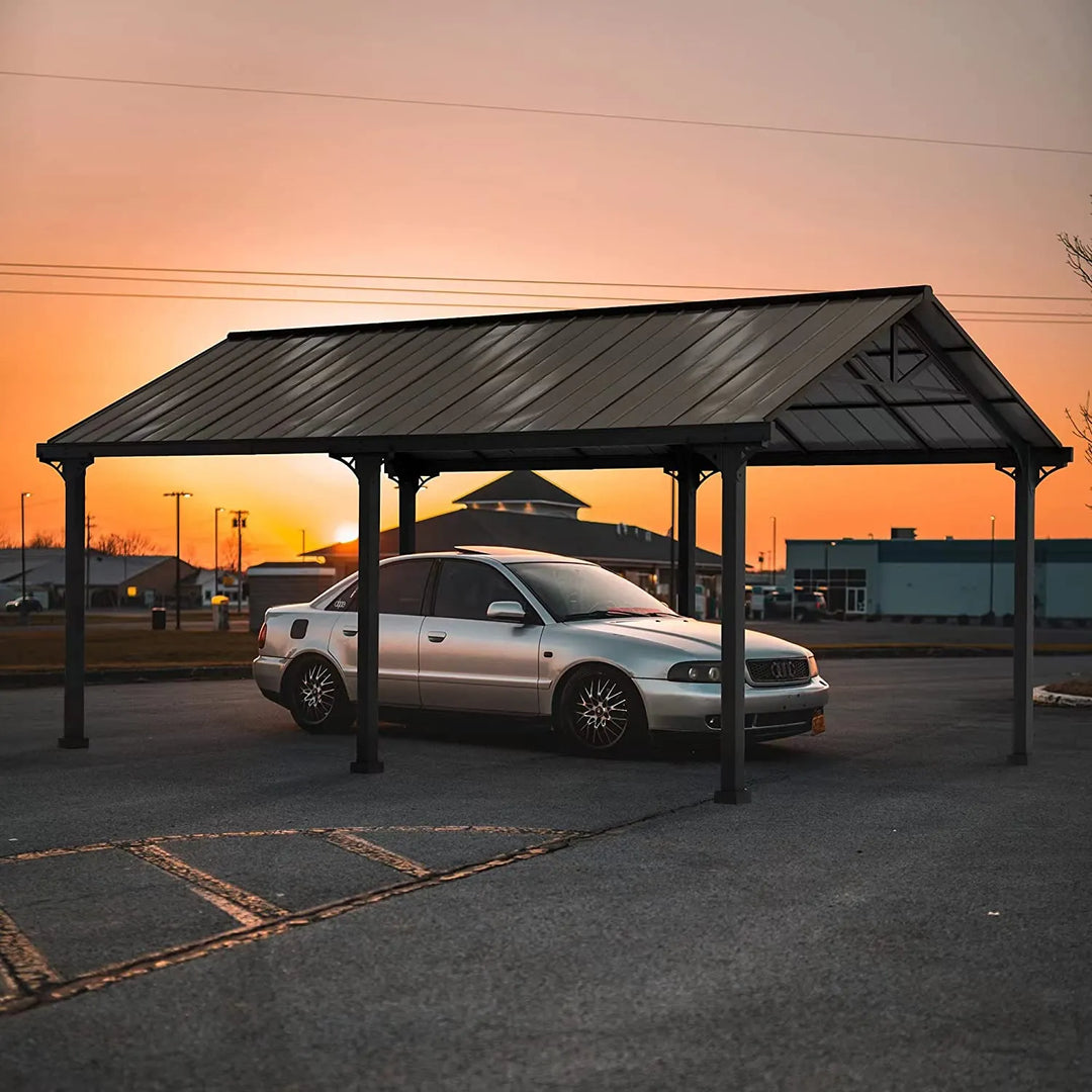 Car parked under a metal carport with a sunset sky in the background