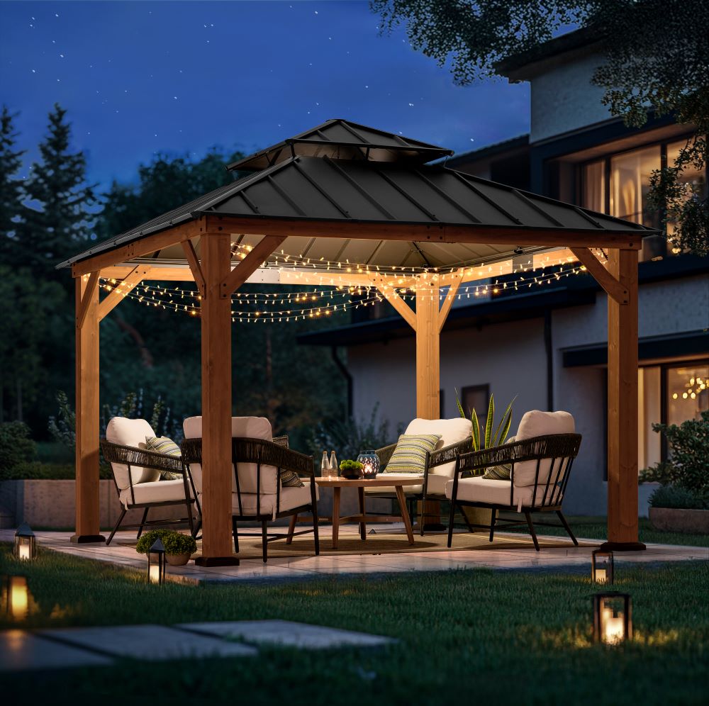 Wooden gazebo with string lights on a patio at night