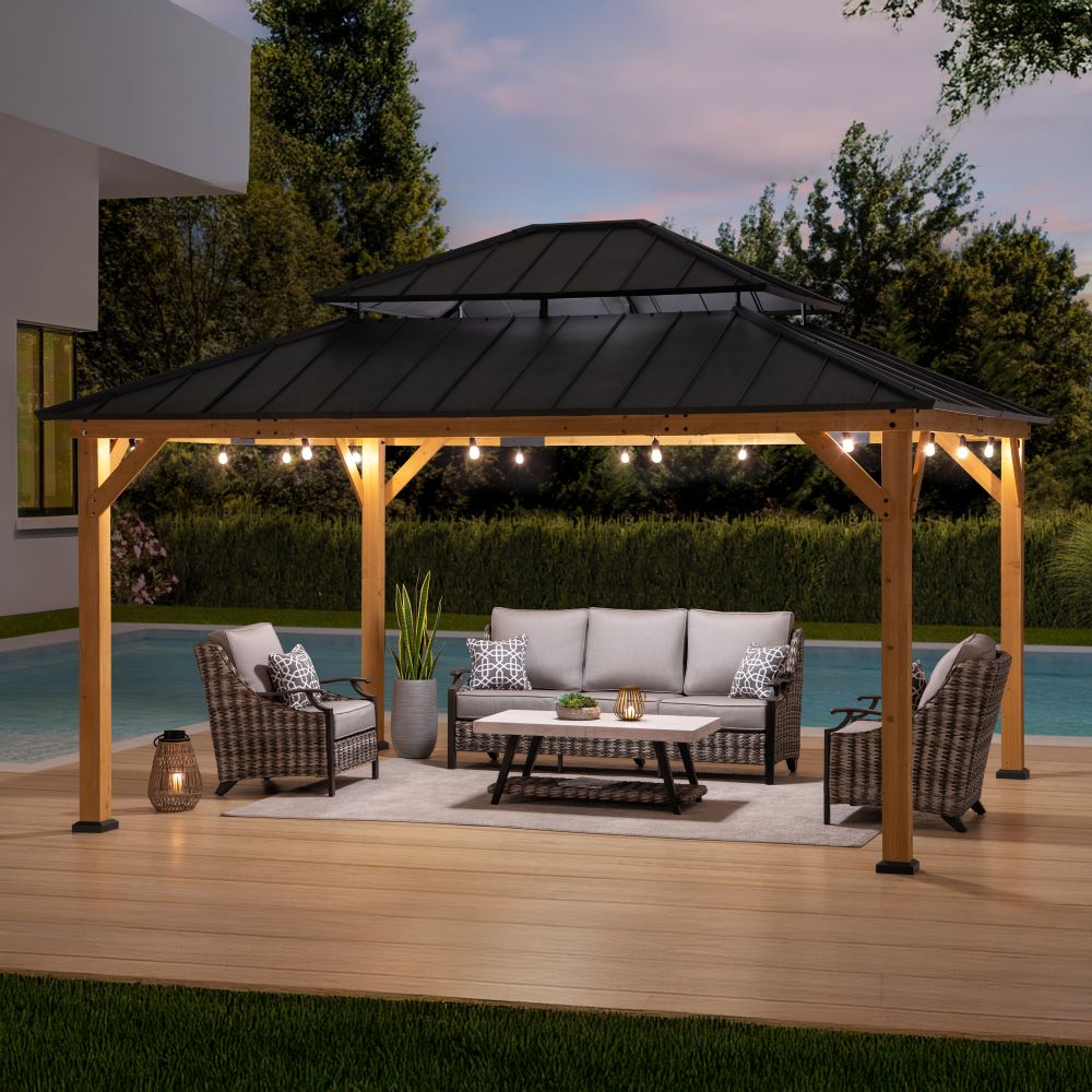 Wooden gazebo with outdoor furniture by a pool at dusk