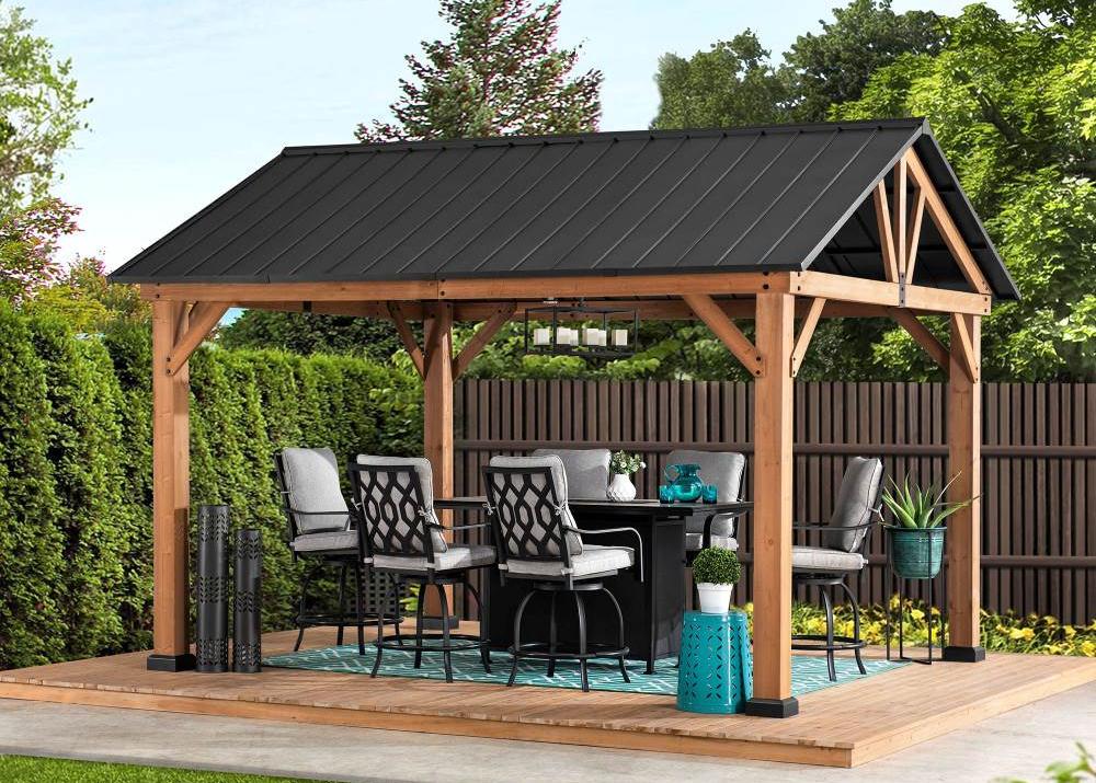 Wooden gazebo with a black roof in a garden setting
