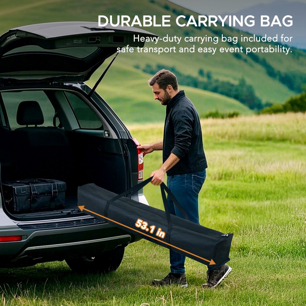 Man unloading a large black carrying bag from an open car trunk in a scenic outdoor setting.