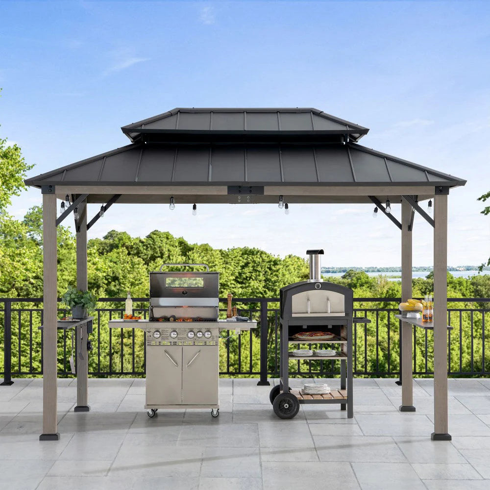 Outdoor gazebo with grill and pizza oven on a patio