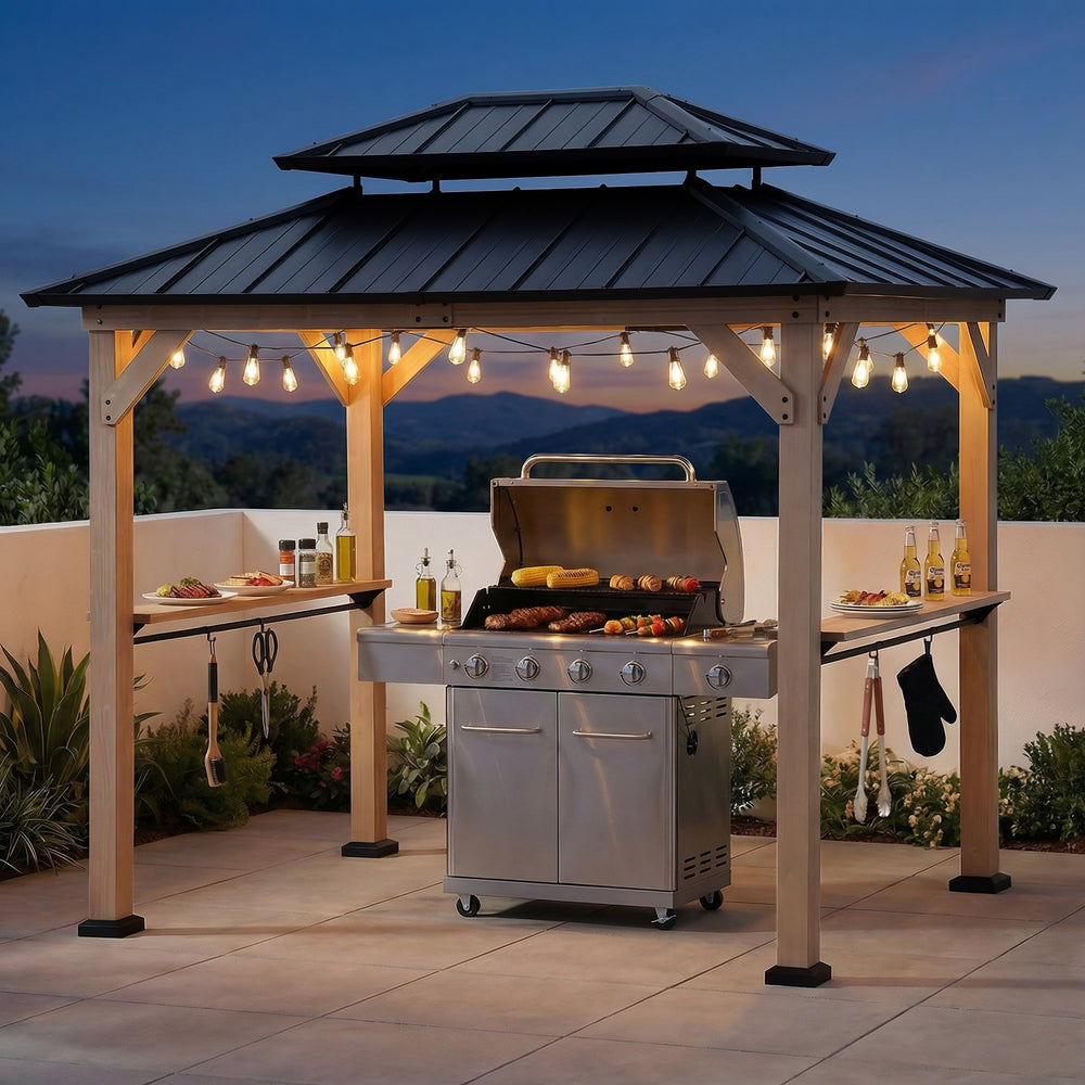 Outdoor grill area with a gazebo and string lights against a mountainous backdrop