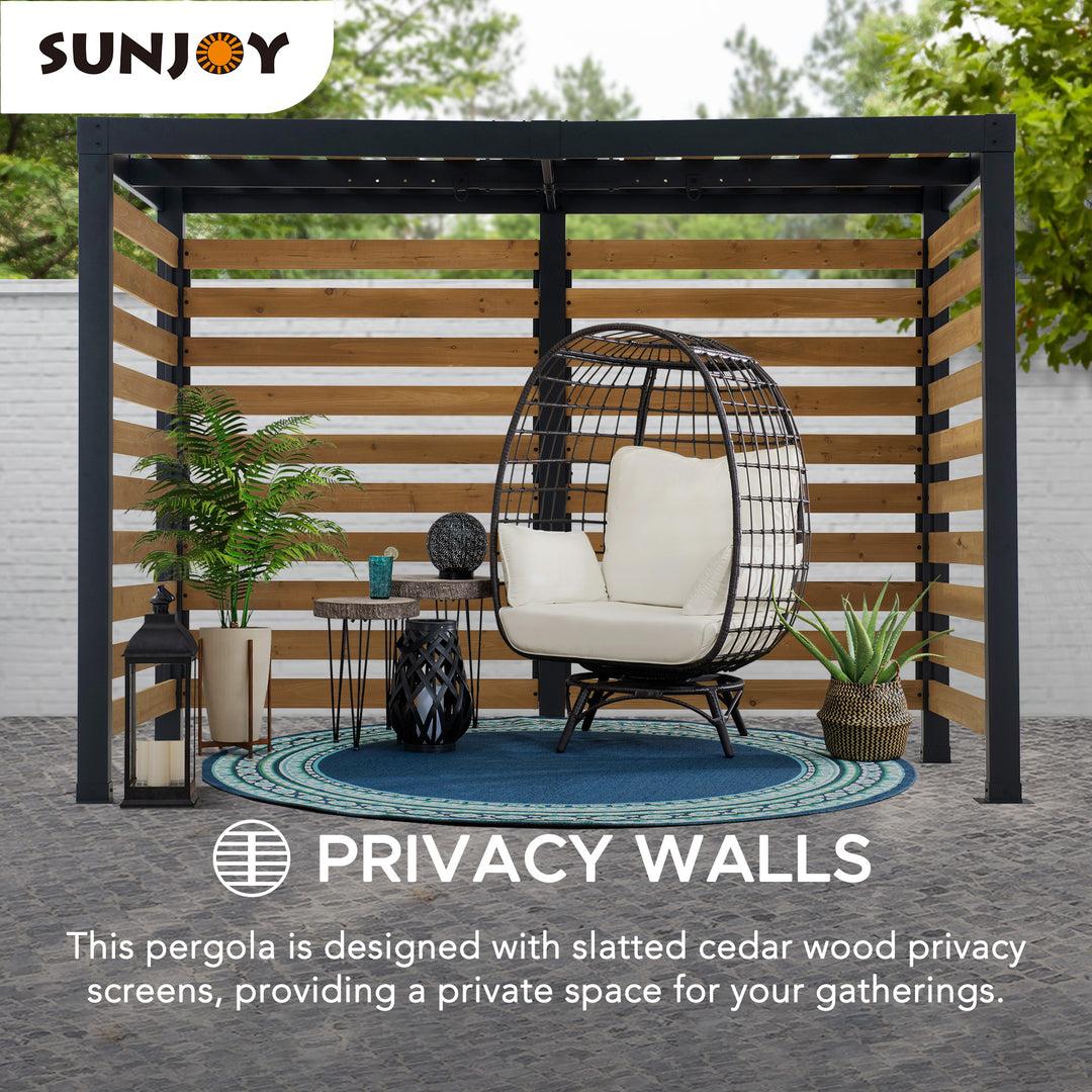 Sunjoy pergola with slatted cedar wood privacy screens, white chair, and decorative elements on a patio.
