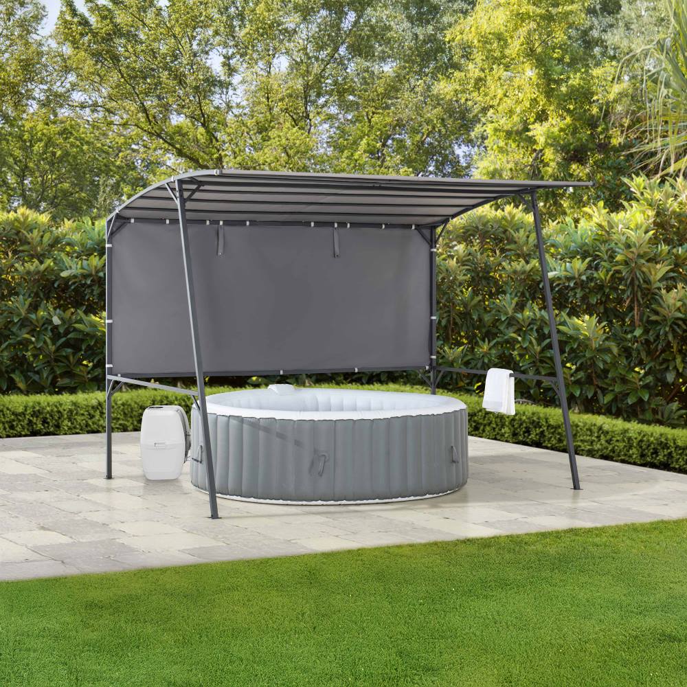 Portable hot tub with canopy in a garden setting