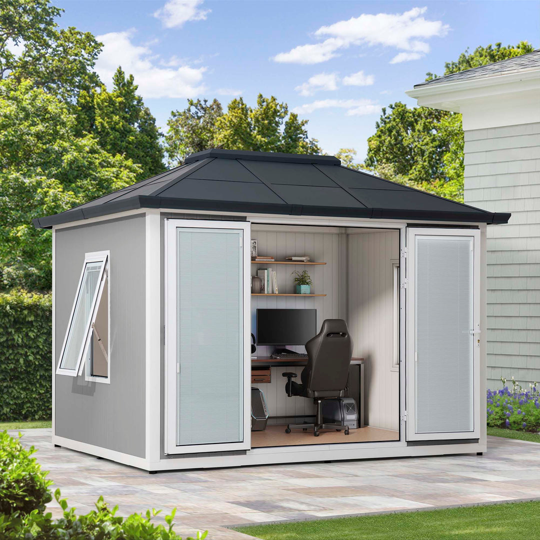 Outdoor office shed with desk, chair, and computer in a garden setting