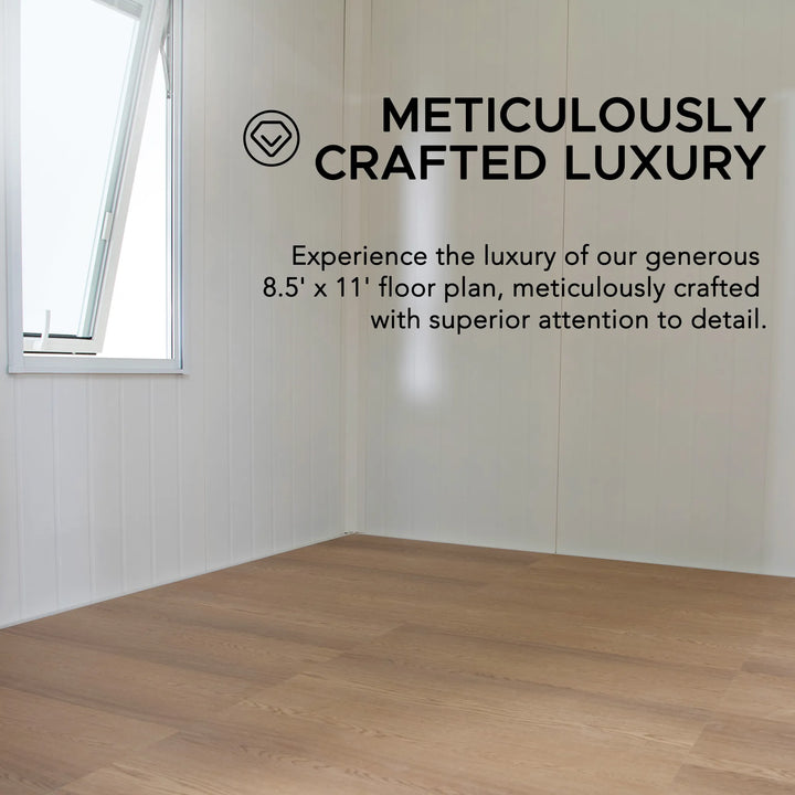 Empty room with wooden flooring and text about meticulously crafted luxury.