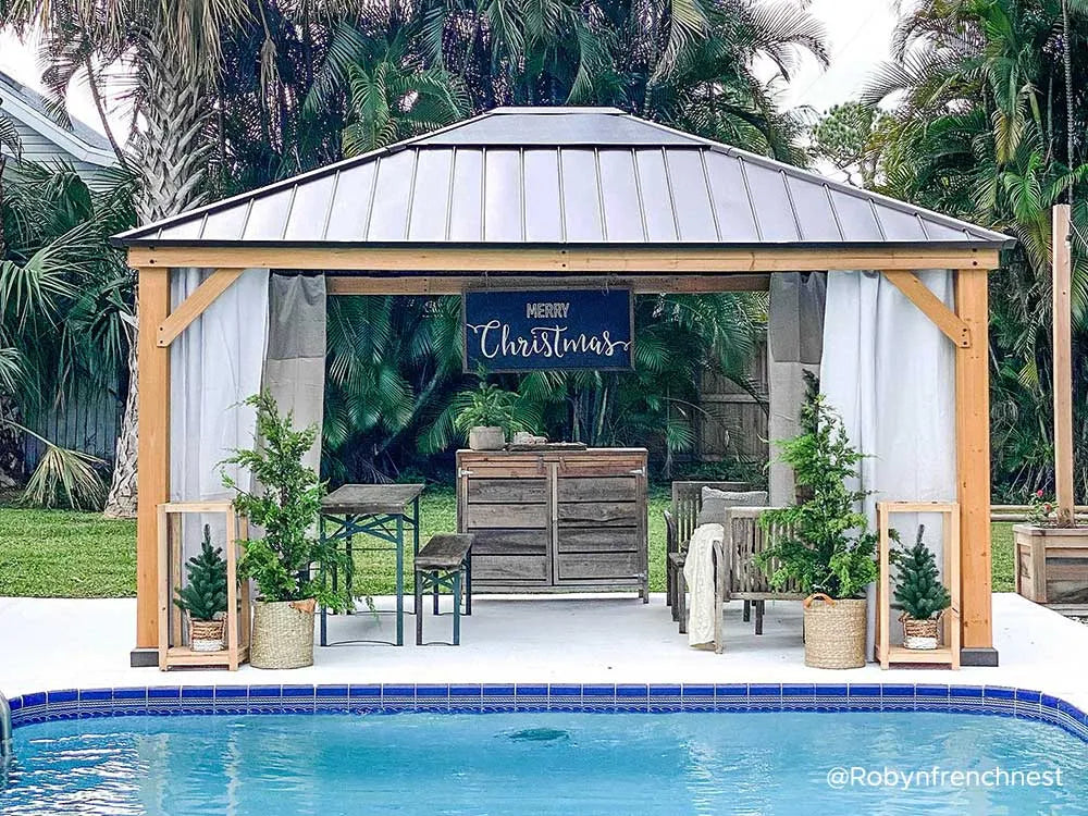 Outdoor gazebo with Christmas decorations by a pool