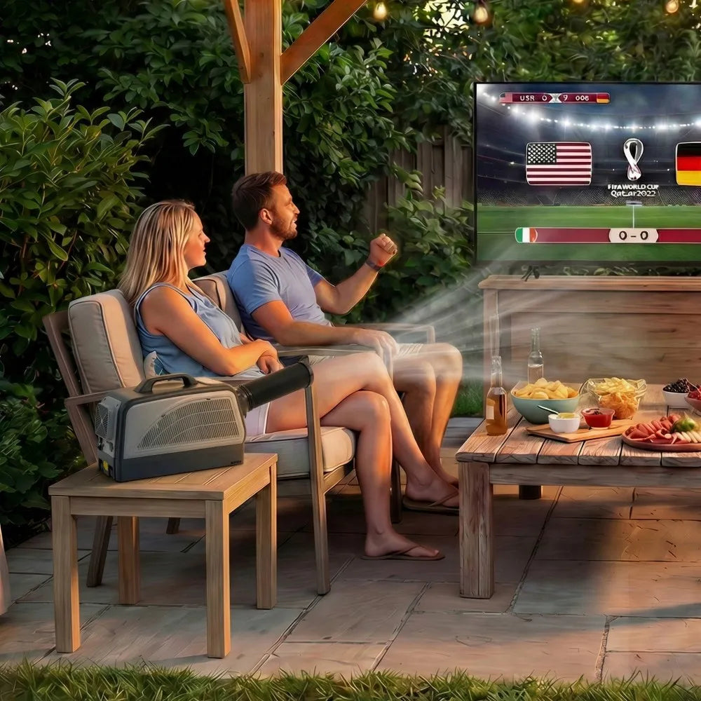 Couple watching a sports game on an outdoor screen projector in a garden setting.