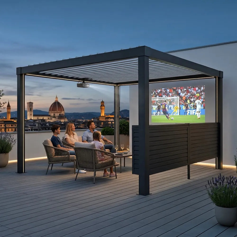 People watching a soccer match on a screen in an outdoor pavilion with city skyline in the background.